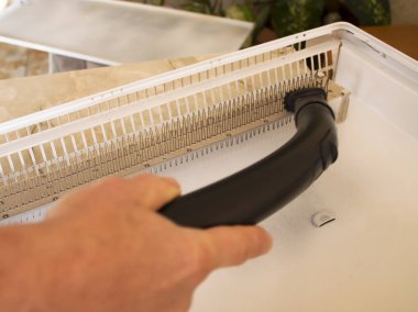 Metal Konvektörü sökülüp formunda. Bir adam bir elektrikli ısıtıcı onarım.