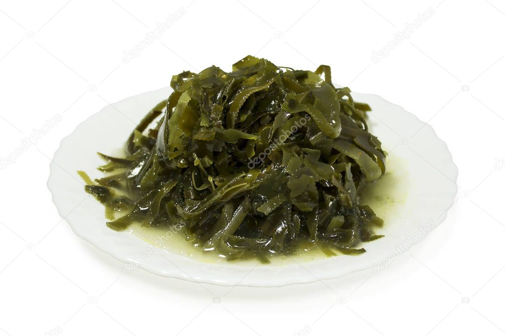 Sea kale, seafood, cut into strips. Laid out on a white plate. Isolated on white background.