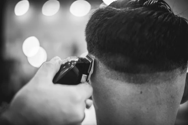 Men\'s haircut in the beauty salon. Barber makes a haircut to the client. Preparing for a haircut.