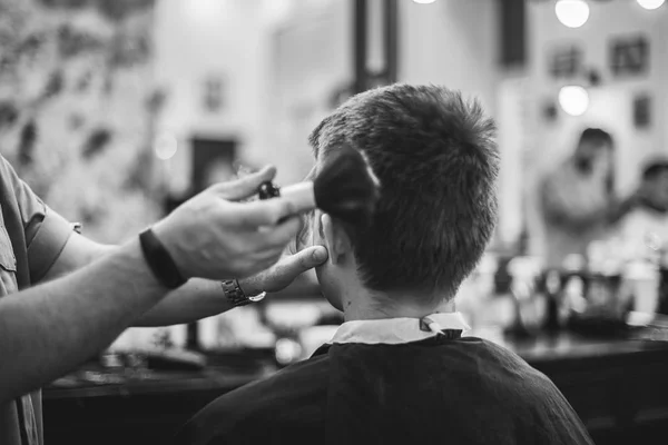 Men's haircut in the beauty salon. Barber makes a haircut to the client. Preparing for a haircut.