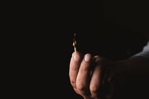 Burning match in the man's hand. Dangerous game with fire. — Stock Photo, Image