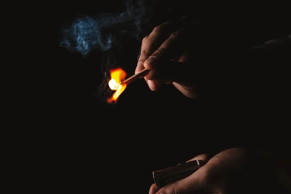 Burning match in the man's hand. Dangerous game with fire. — Stock Photo, Image