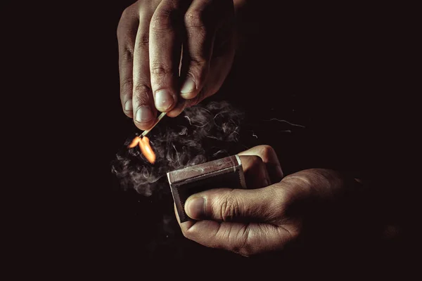 Burning match in the man's hand. Dangerous game with fire. — Stock Photo, Image