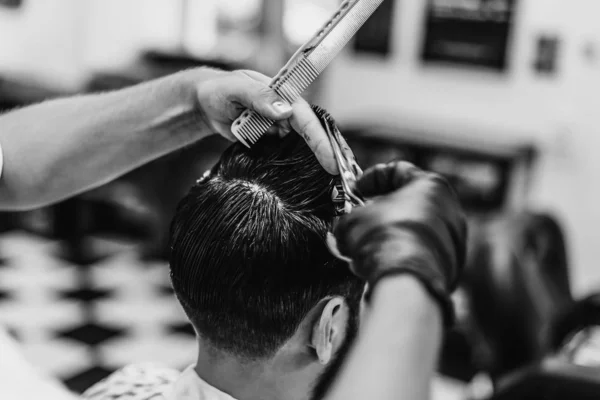 Man haircut in barbershop. Black and white photo. Retro style.