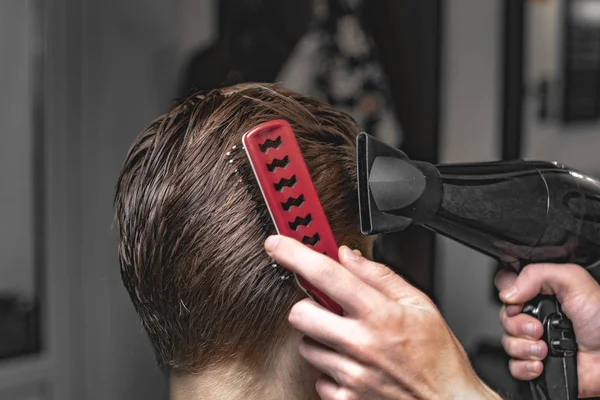 Barber does hair styling. Men's Hair Care.