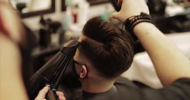 Haarstyling. Barber voltooit het kapsel. — Stockvideo