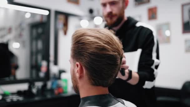 Barber finishes his haircut. Classic retro haircut. — Stock Video