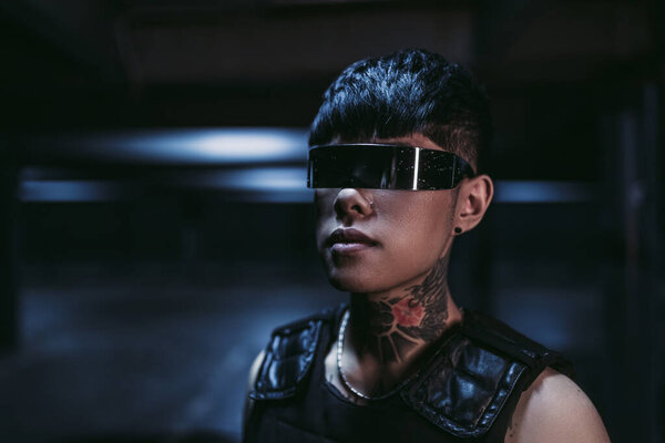 Cyberpunk style. Tattooed guy in one city. Cyber glasses.