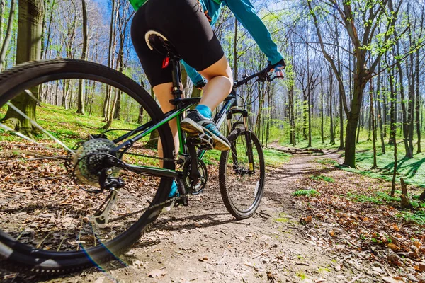 Young woman ride bicycle in forest by trail — Stock Photo, Image