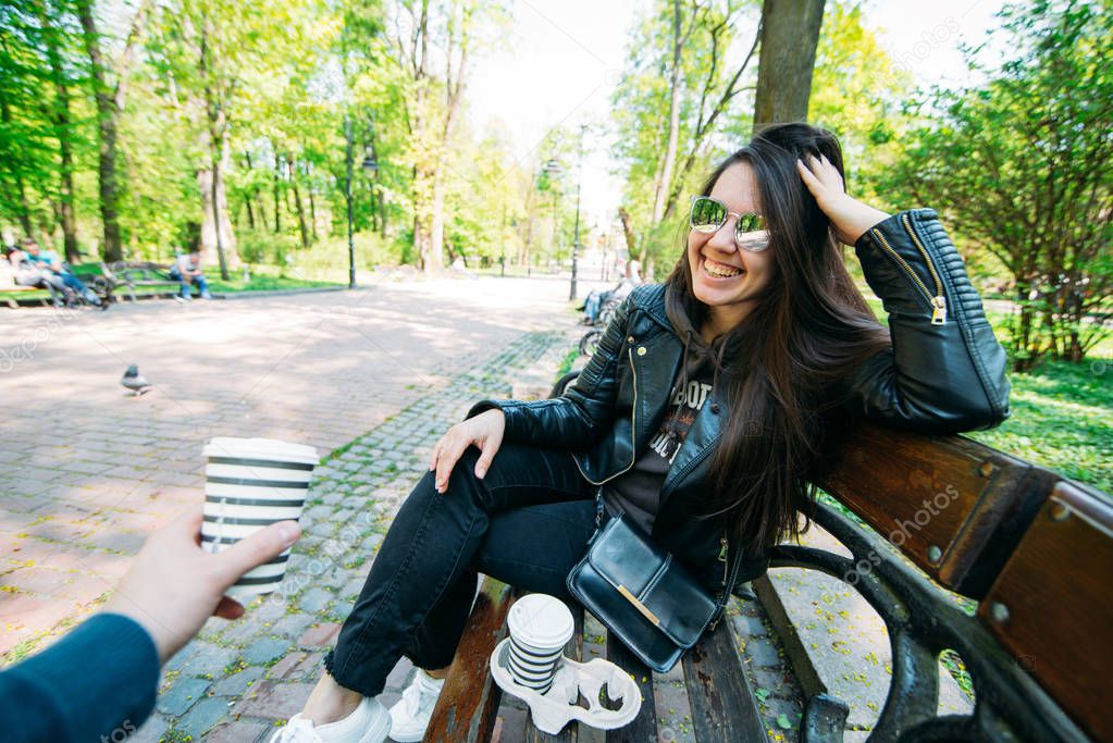 couple sitting on bench drinking coffee. lifestyle concept