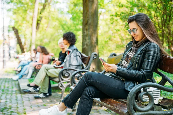 Woman Sitting Bench City Park Drinking Coffee Surfing Internet Mobile — Stock Photo, Image