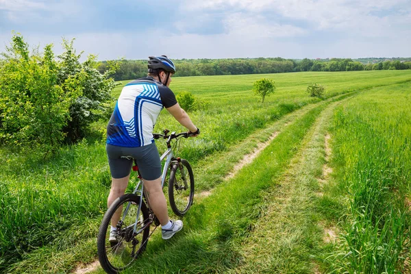 Man Riding Bicycle Trail Green Barley Field Copy Space — Stock Photo, Image