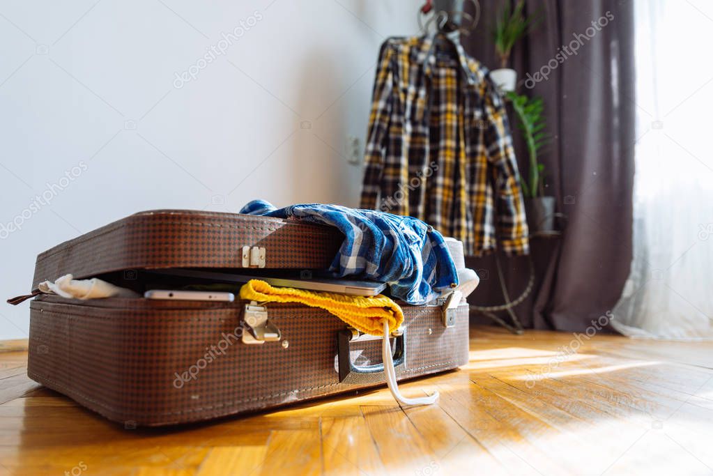 overloaded suitcase with clothes. travel concept. bag with garment