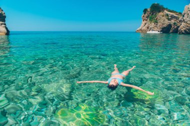 Açık mavi deniz suyu arkaya yüzme kadın. yaz tatil kavramı