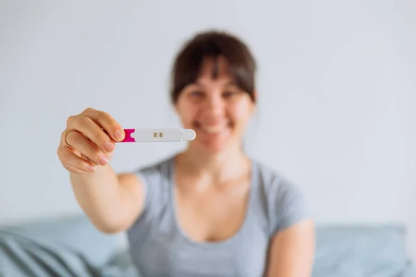 Young Happy Woman Sitting Bed Looking Positive Pregnancy Test Blurred — Stock Photo, Image