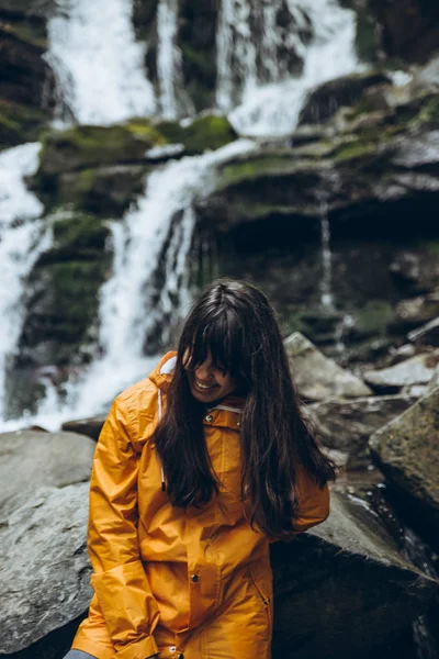 Mulher Sorridente Capa Chuva Amarela Com Cachoeira Fundo Conceito Caminhadas — Fotografia de Stock