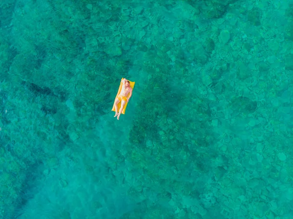 Man Gele Opblaasbare Matras Helder Zeewater Met Rotsachtige Bodem Zomer — Stockfoto