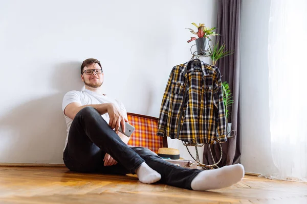 young man sit on floor . valise packing for trip.travel concept. copy space.