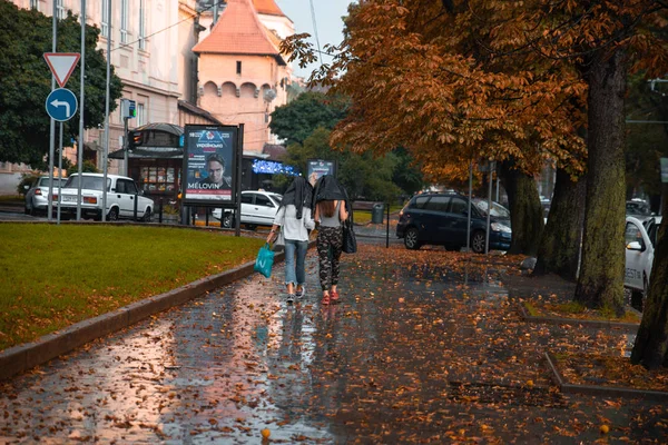 Lviv, Ukrayna - 7 Eylül 2018: yağmur kat altında gizli iki genç yetişkin kadın — Stok fotoğraf