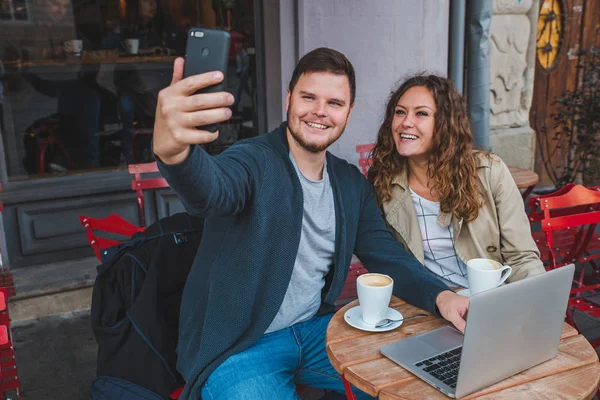 Couple Sitting Cafe Man Working Laptop Woman Taking Picture Phone — Stock Photo, Image