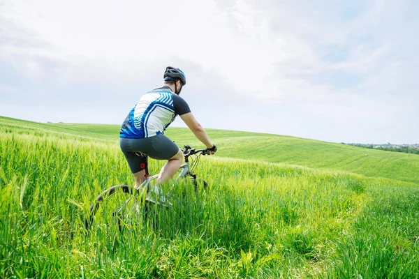 Young Strong Man Riding Bicycle Green Field — Stock Photo, Image