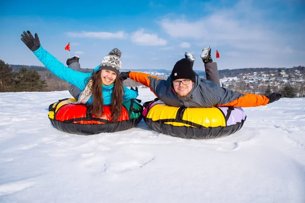 friends having fun. snow tubing. winter activity. ride from the hill