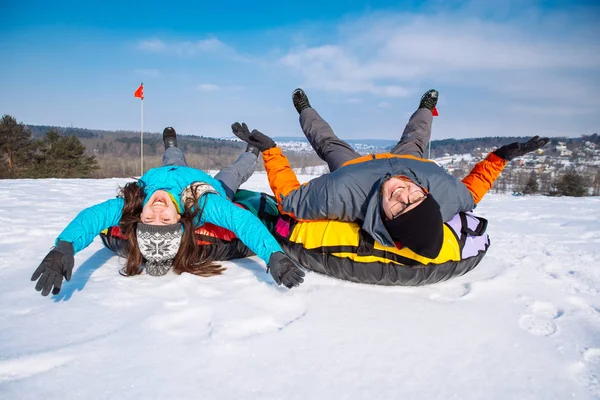 friends having fun. snow tubing. winter activity. ride from the hill