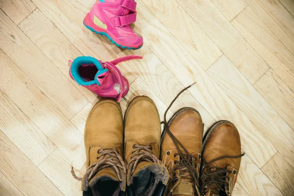 father, mother and daughter shoes. overhead view