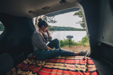 SUV bagaja oturan kadın. araba seyahat kavramı. Yaz saati