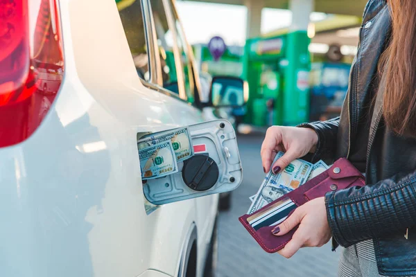 woman with wallet. put money to car tank. car fueling up concept