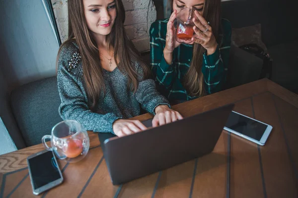 दोन आधुनिक स्त्रिया कॅफेमध्ये बैठक घेत आहेत. लॅपटॉप अँट टॅब्लेटवर काम करणे — स्टॉक फोटो, इमेज