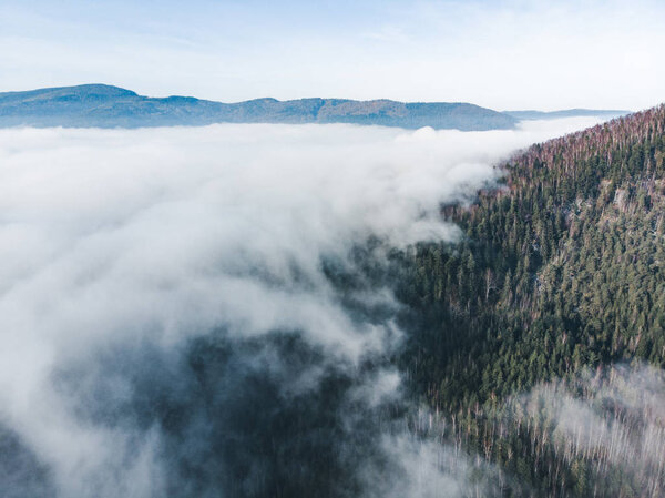 aerial view of clods and fog over mountains hills. magic time. beautiful nature