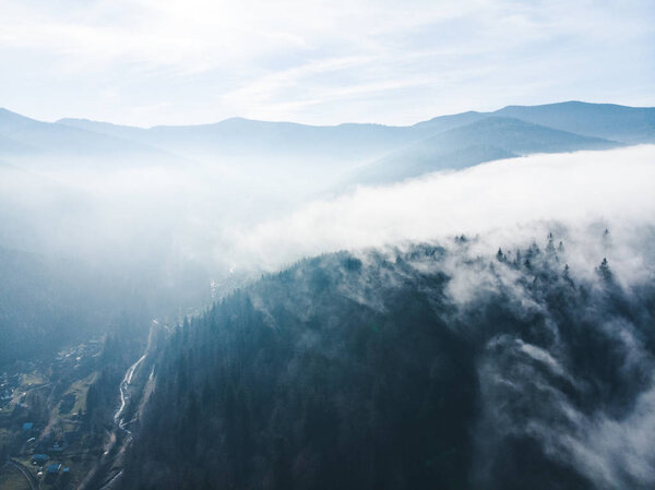 aerial view of clods and fog over mountains hills. magic time. beautiful nature