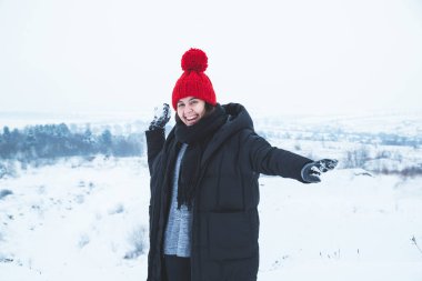 kartopu atarak genç gülümseyen kadın. karlı havalarda açık havada oyun