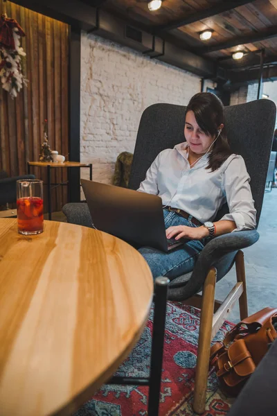 Woman Sitting Big Chair Cafe Laptop Listening Music Headset Drinking — Stock Photo, Image