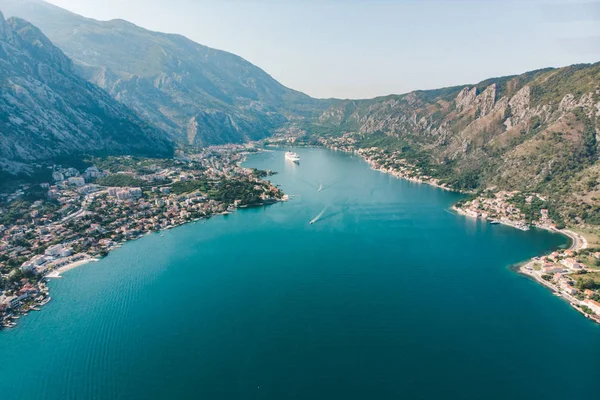 summer time. aerial view of sea bay with boats and cruise liner. mountains range