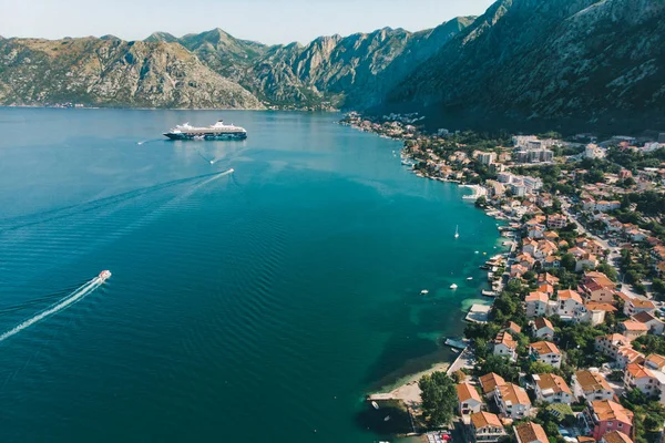 summer time. aerial view of sea bay with boats and cruise liner. mountains range