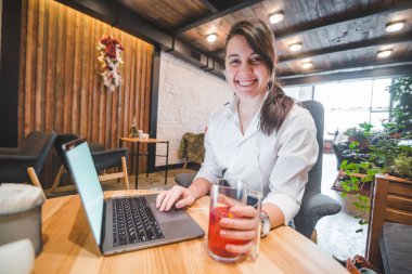 laptop ve meyve çay dinleme müzik kulaklık kadınla kafede. Freelancer kavramı