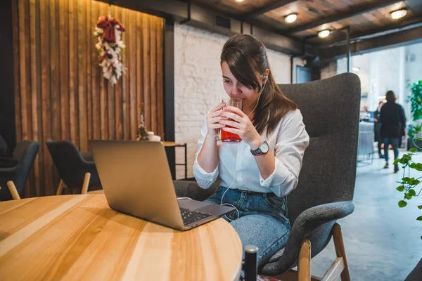 Woman Sitting Big Chair Cafe Laptop Listening Music Headset Drinking — Stock Photo, Image