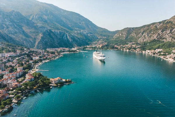 summer time. aerial view of sea bay with boats and cruise liner. mountains range