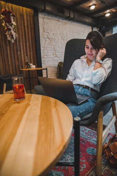 Woman Sitting Big Chair Cafe Laptop Listening Music Headset Drinking — Stock Photo, Image