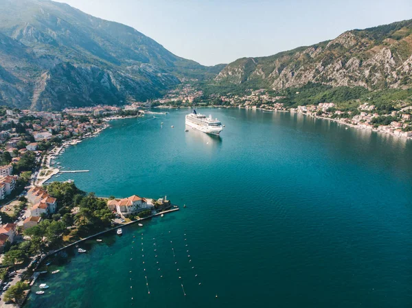 summer time. aerial view of sea bay with boats and cruise liner. mountains range