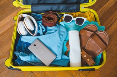 seyahat kavramı. Sarı çanta etrafında farklı şeyler ile. Üstten Görünüm