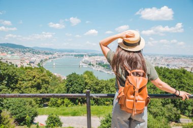 young stylish woman looking at panoramic view of budapest city clipart