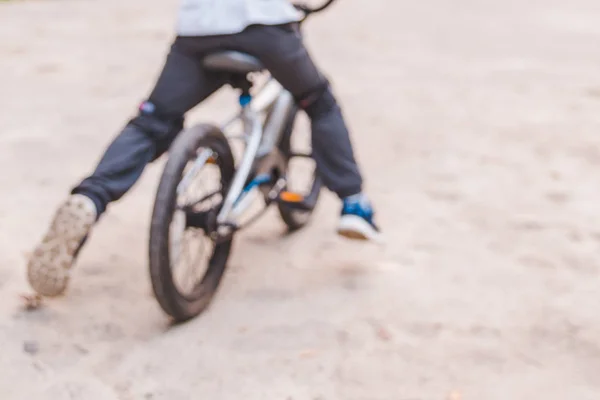 Blurred picture little kid ride bicycle — Stock Photo, Image