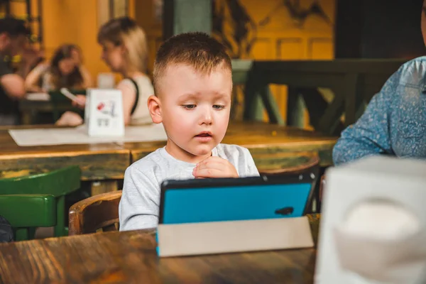 Little boy sitting with tablet — Stock Photo, Image