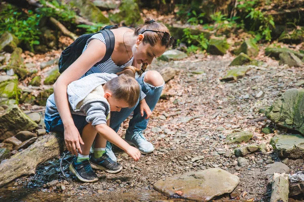 Mère avec enfant près de montagne rivière — Photo