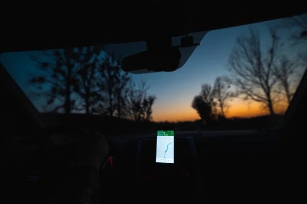 view from inside of car navigation on phone. sunrise