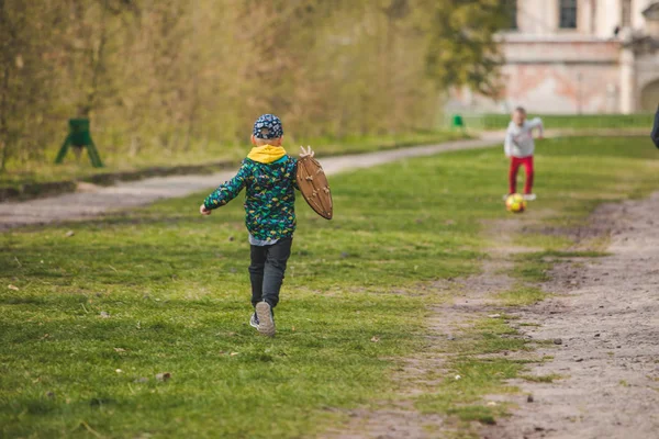 Niños jugando con pelota y escudo de madera — Foto de Stock