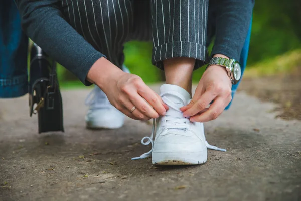 Donna cravatta lacci sulle scarpe da ginnastica — Foto Stock